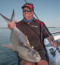 permit fishing season angler holds up a nice Key West permit